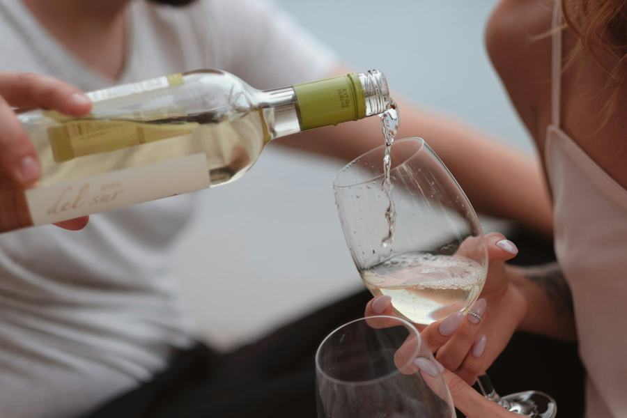 White wine being poured at a tasting